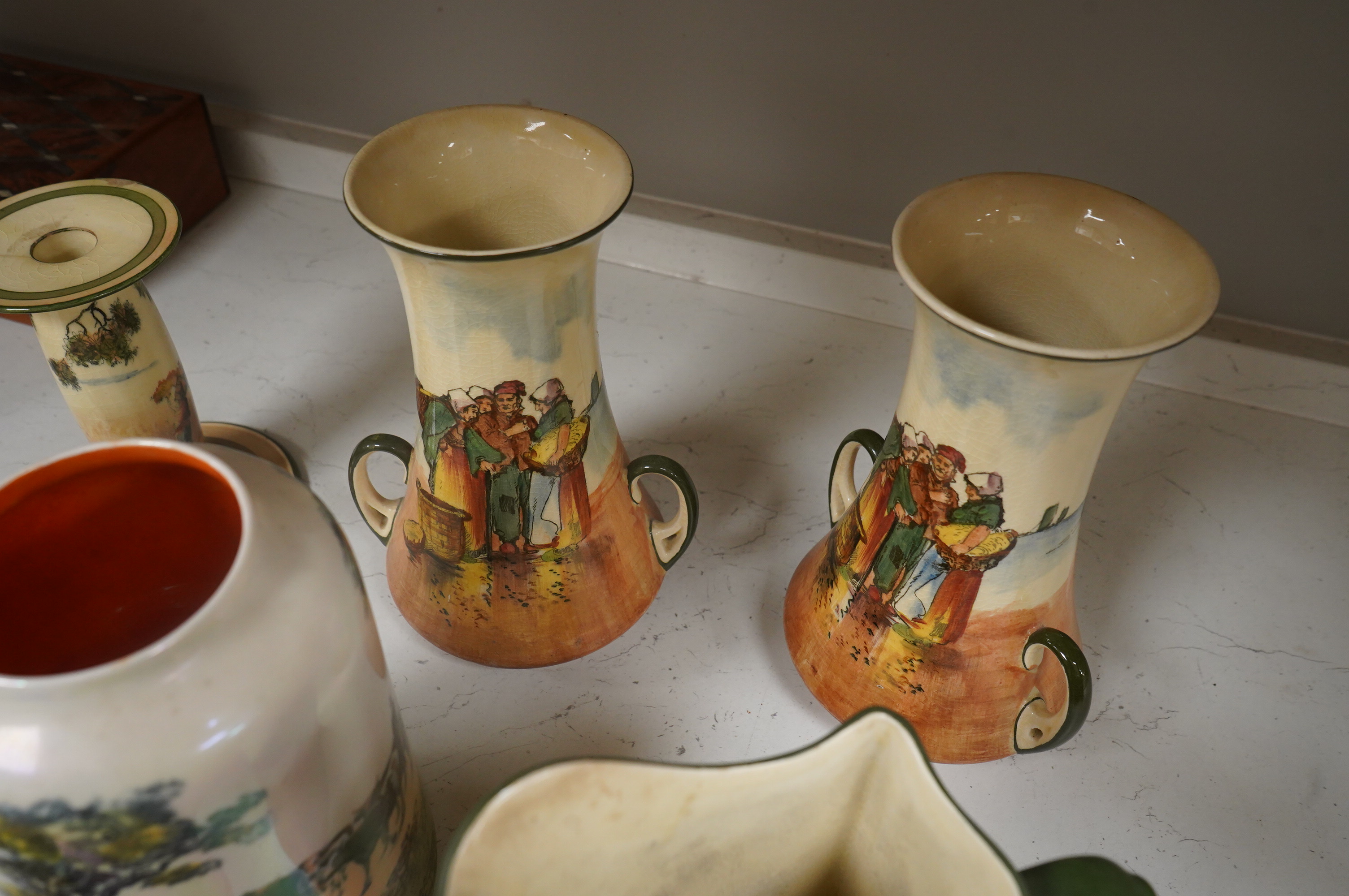 A collection of Royal Doulton series ware jugs, vases and candlesticks, largest 22cm high